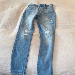 Light wash, ripped knee skinny jeans